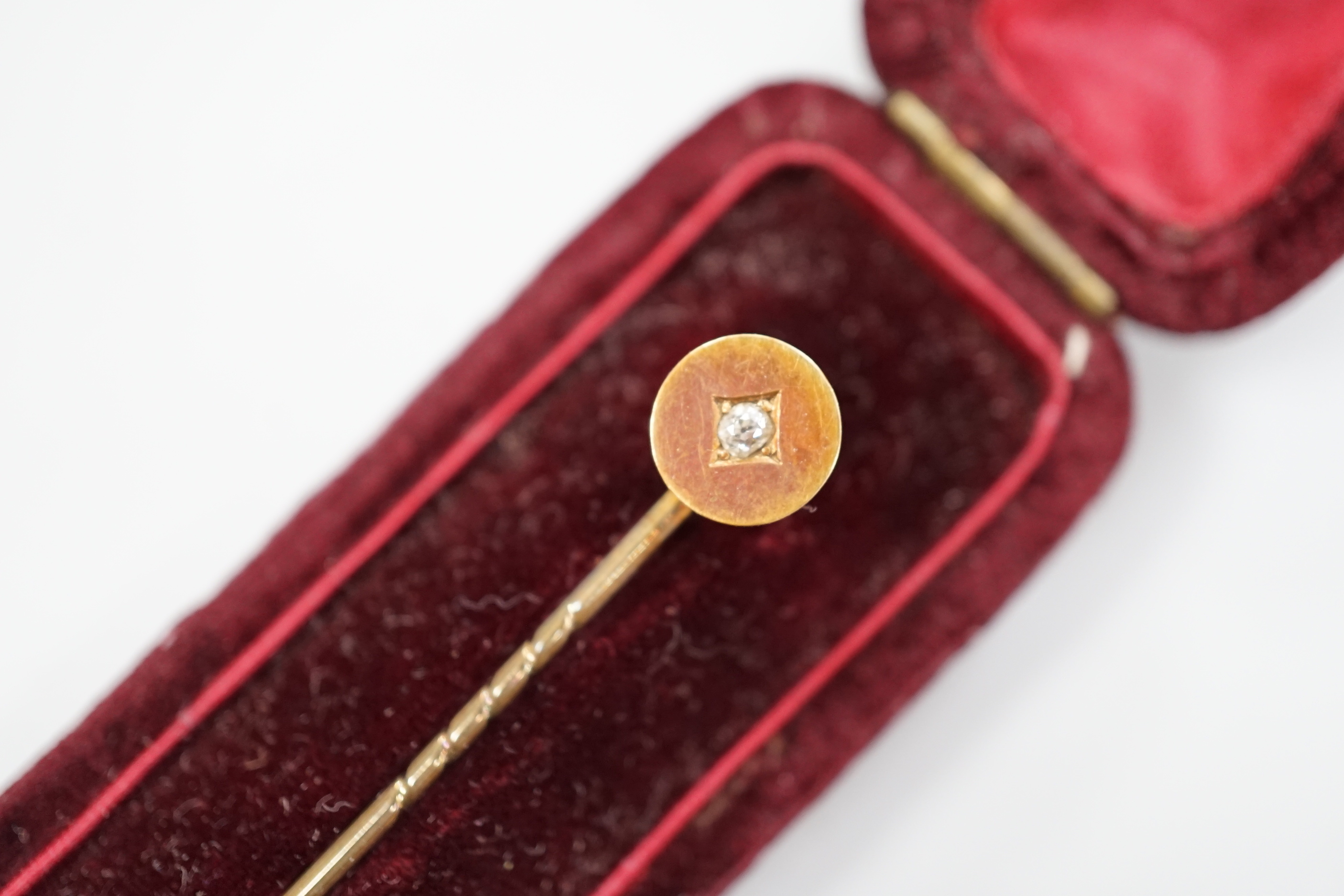 A Victorian yellow metal oval morning locket, with hair beneath a glazed panel verso, overall 56mm and four other items including a pinchbeck bangle.